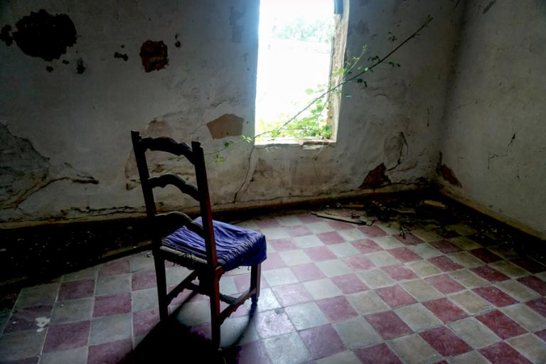 Exploring Abandoned Towns in Italy That Feel Frozen in Time 5 abandoned house with a chair