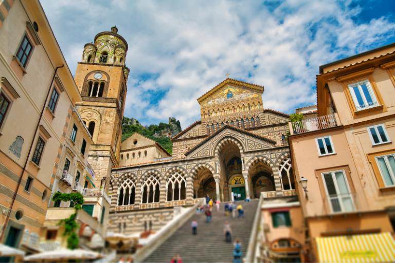 a group of people walking up a staircase in Amalfi