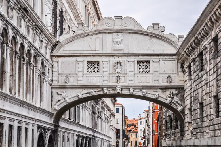 a stone bridge over a canal | Bridge of Sighs in Venice