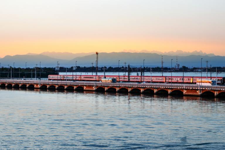 a train crossing a bridge over water