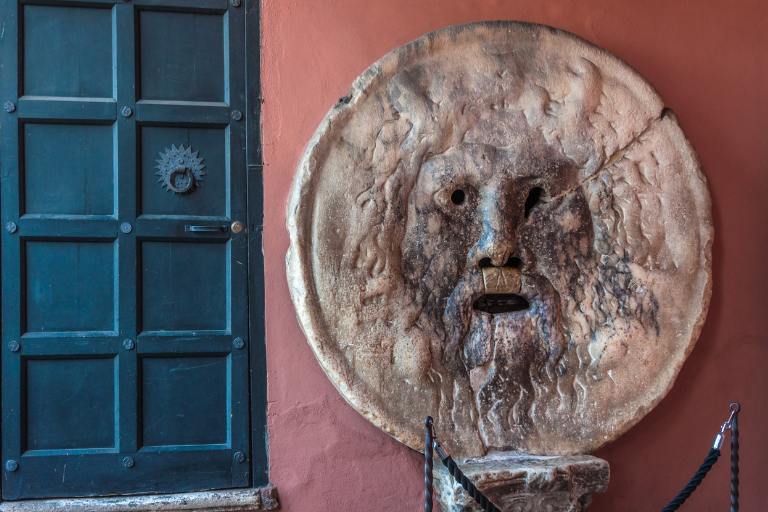 a stone face with a mouth on a wall | Bocca della Verità 