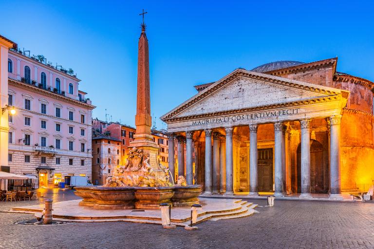 a fountain with an obelisk in front of the pantheon in rome