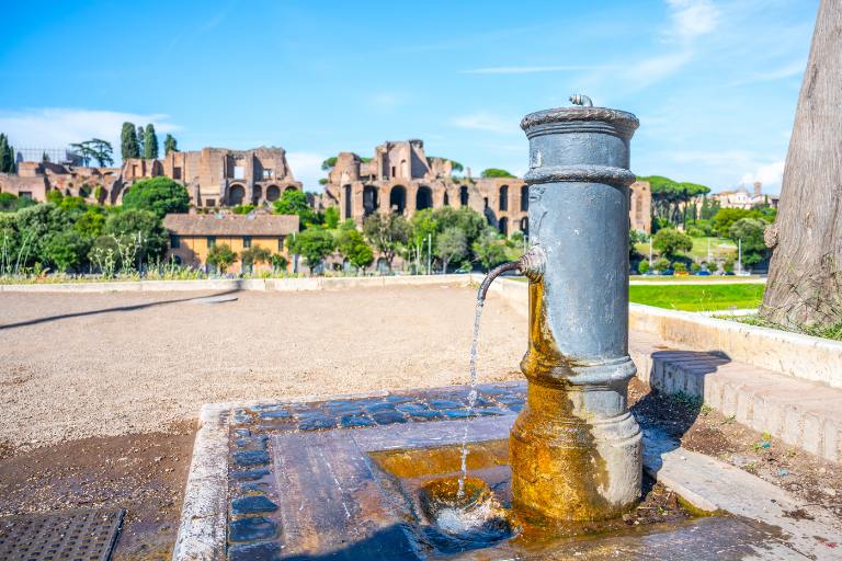 a water fountain with a stone base and a stone floor