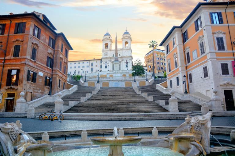 a fountain in front of a building | where to stay in italy