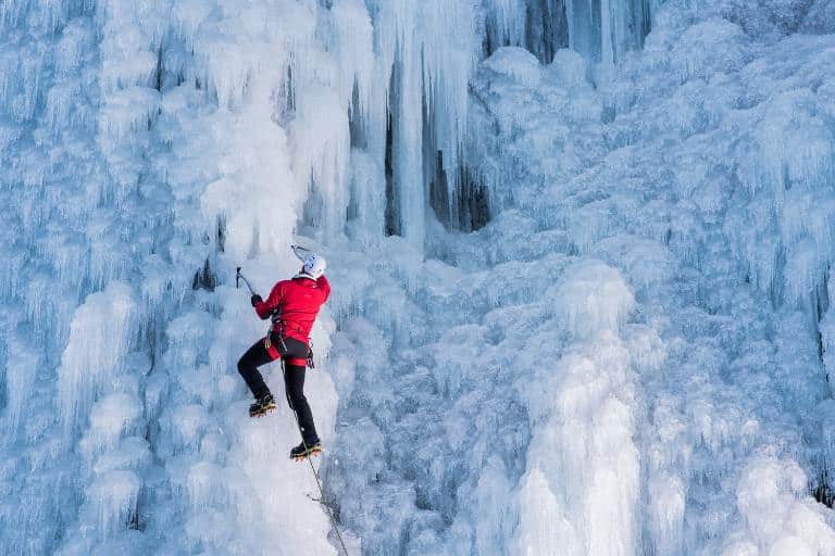 person climbing an ice mountain