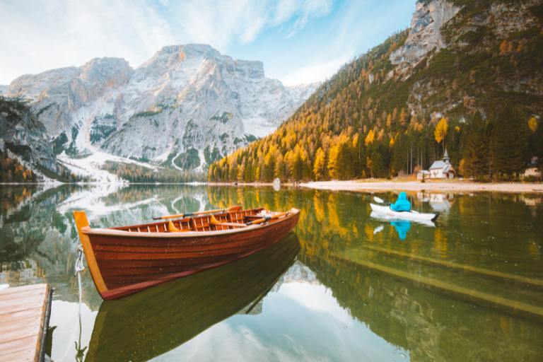 a boat on a lake with mountains in the background