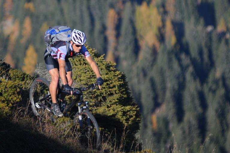 a man riding a bike on a hill