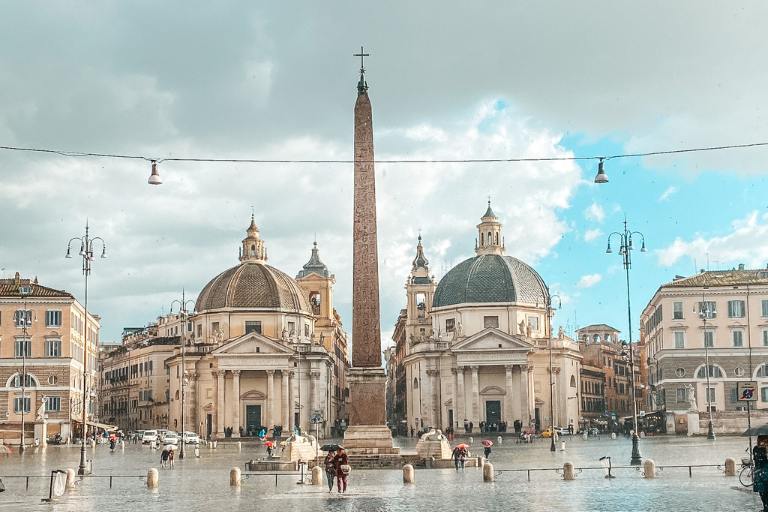 a large obelisk in a square with buildings and a fountain in Piazza del Popolo 